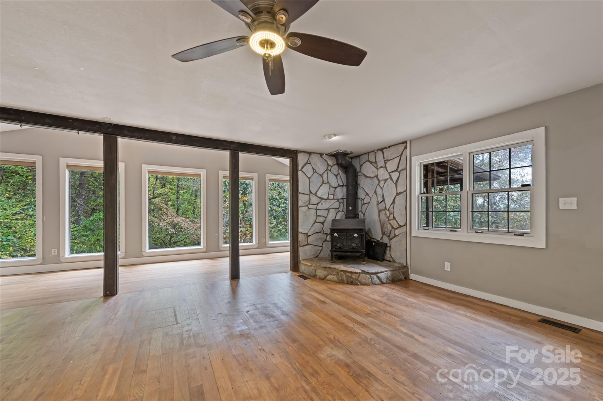 940 Haynes Cove Clyde, NC 28721 - Photo 18 of 48 a view of an empty room with a window and wooden floor