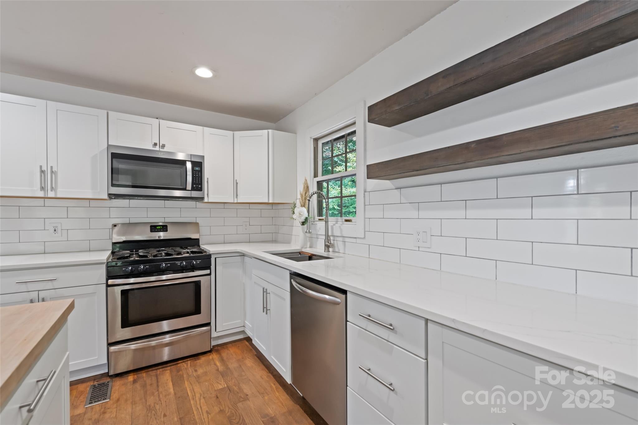 940 Haynes Cove Clyde, NC 28721 - Photo 23 of 48 a kitchen with a sink stove and microwave