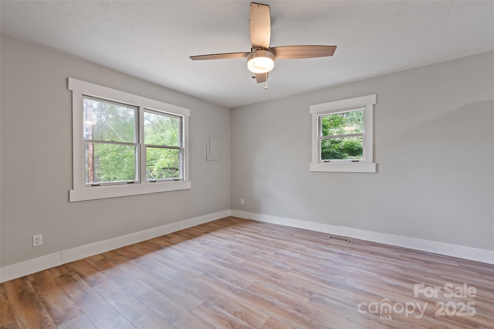 940 Haynes Cove Clyde, NC 28721 - Photo 25 of 48 a view of an empty room with wooden floor and a window