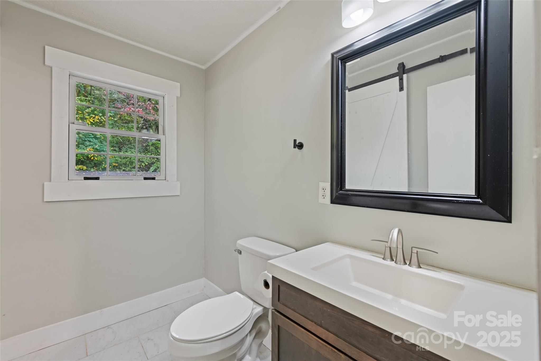 940 Haynes Cove Clyde, NC 28721 - Photo 27 of 48 a bathroom with a granite countertop toilet sink and mirror