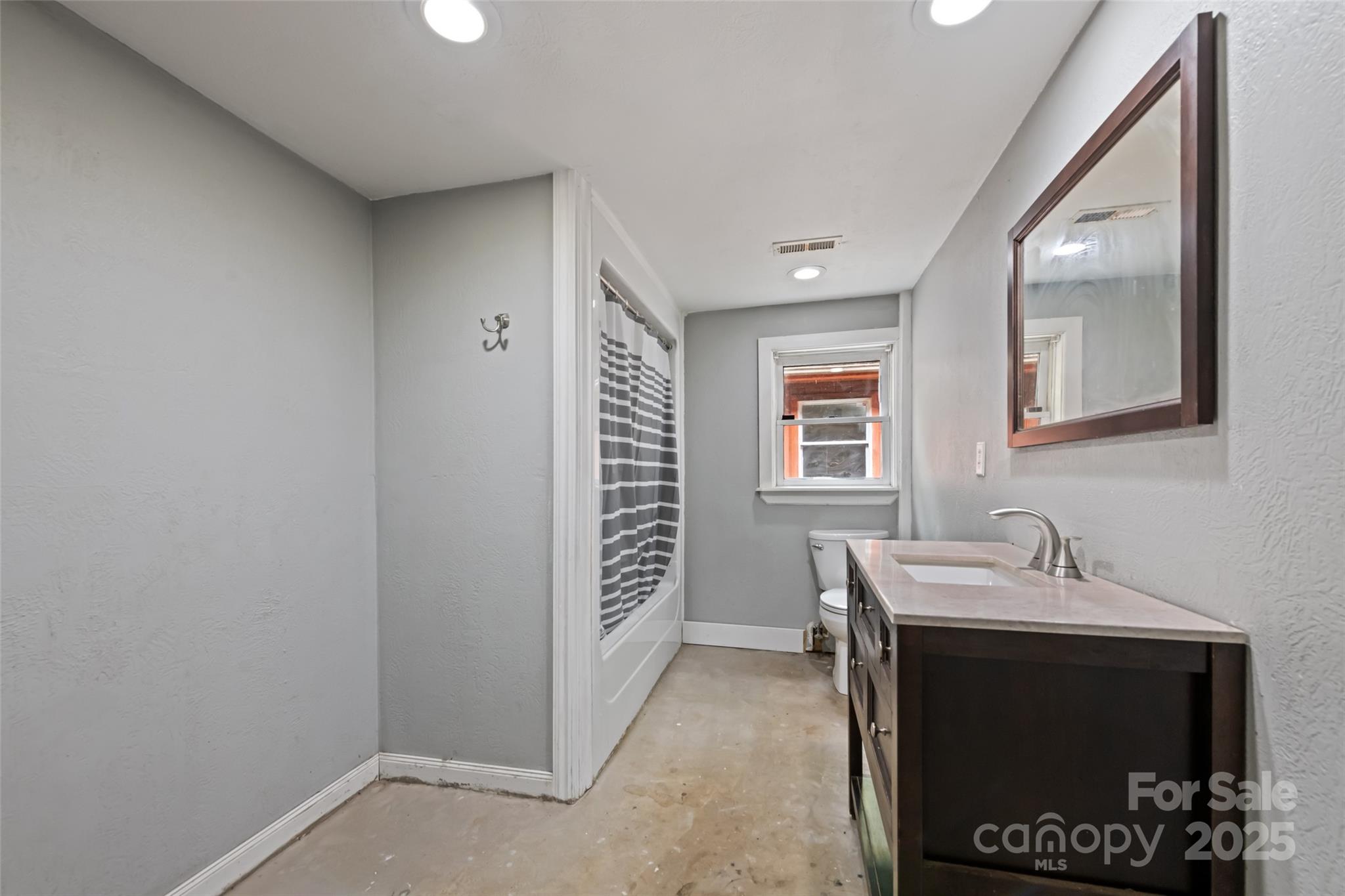 940 Haynes Cove Clyde, NC 28721 - Photo 33 of 48 a hallway with a sink and a mirror