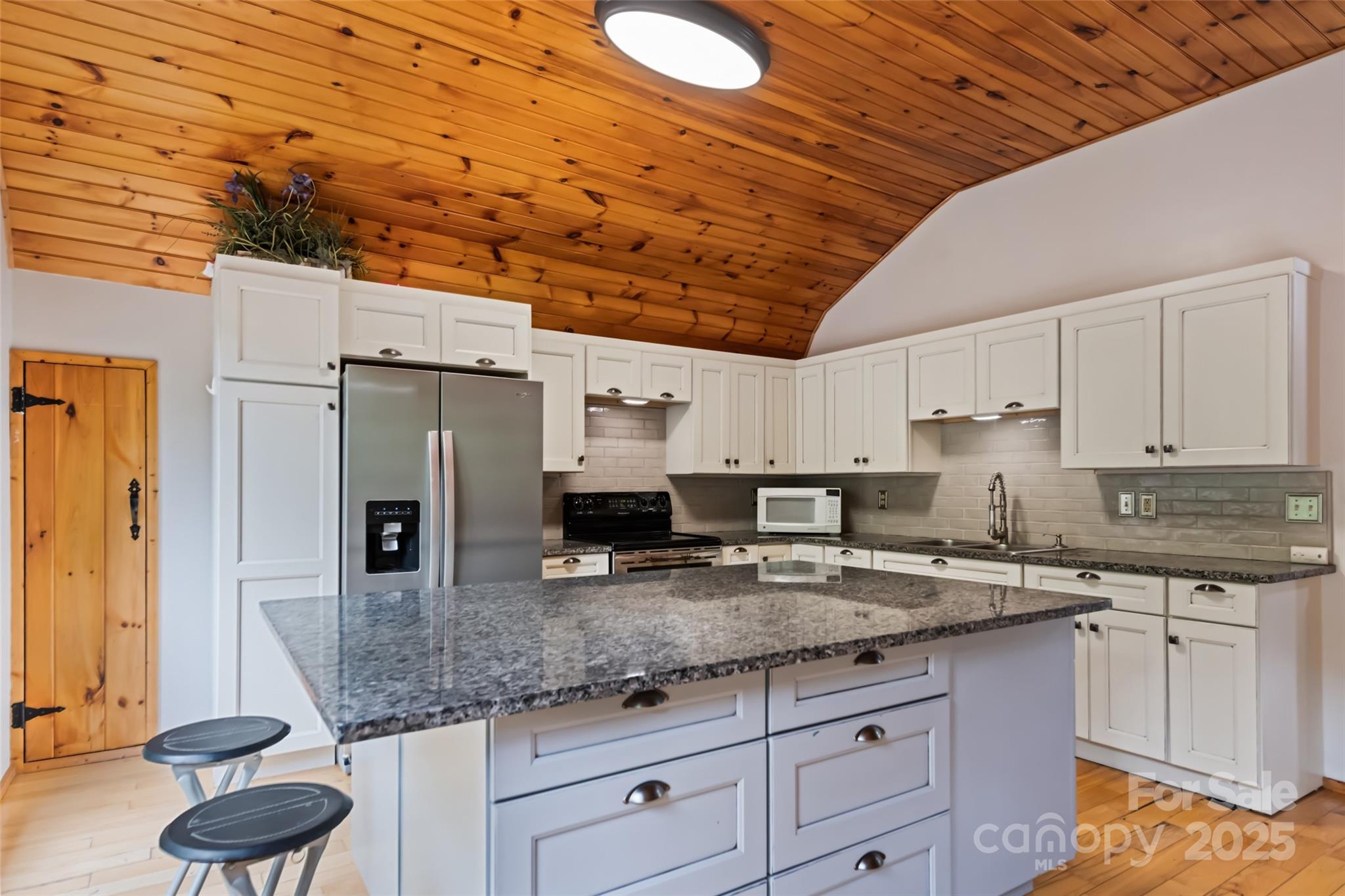 940 Haynes Cove Clyde, NC 28721 - Photo 40 of 48 a kitchen with granite countertop a sink a counter space and stainless steel appliances