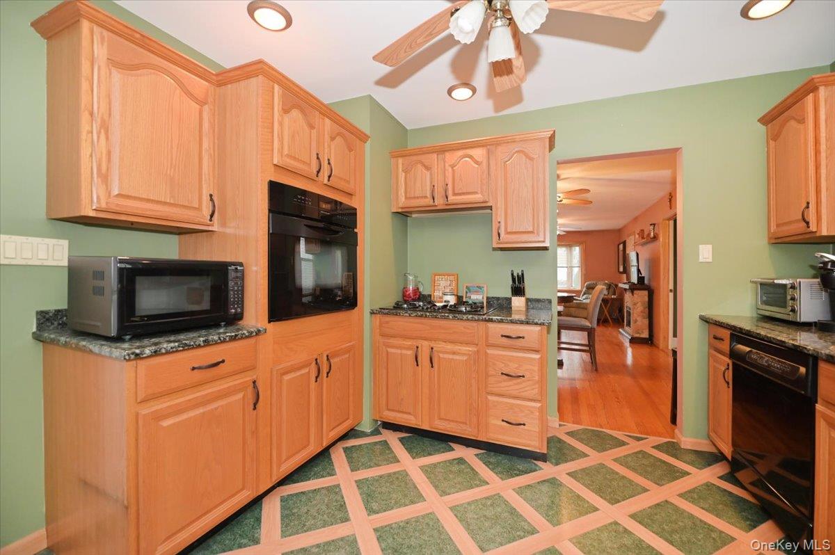 2016 Abbot Avenue Merrick, NY 11566 - Photo 13 of 26 a kitchen with stainless steel appliances a stove microwave and cabinets