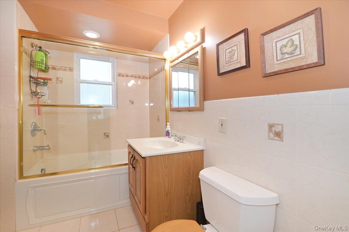 2016 Abbot Avenue Merrick, NY 11566 - Photo 21 of 26 a bathroom with a sink a toilet and shower