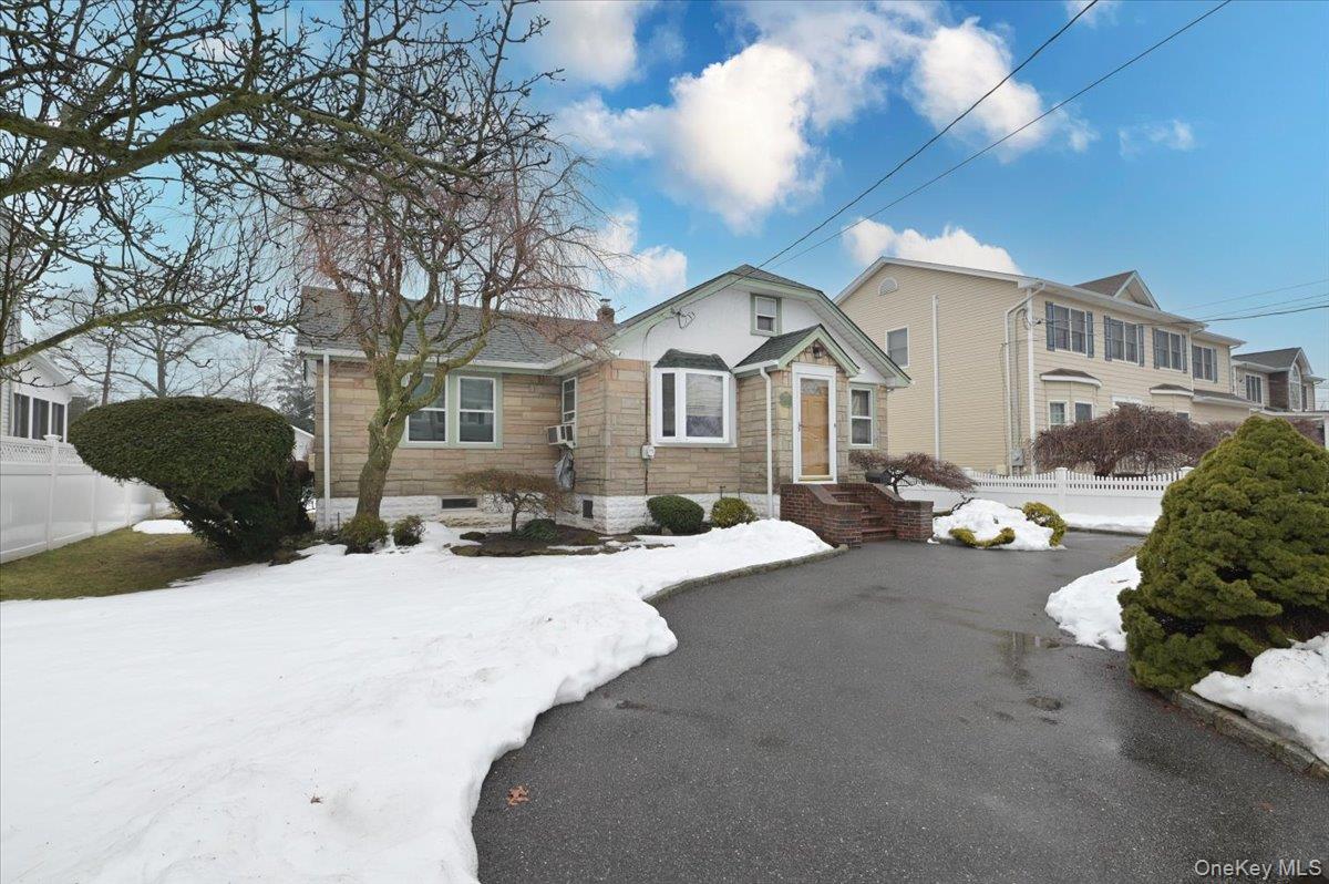 2016 Abbot Avenue Merrick, NY 11566 - Photo 4 of 26 a view of a house with a yard covered in snow