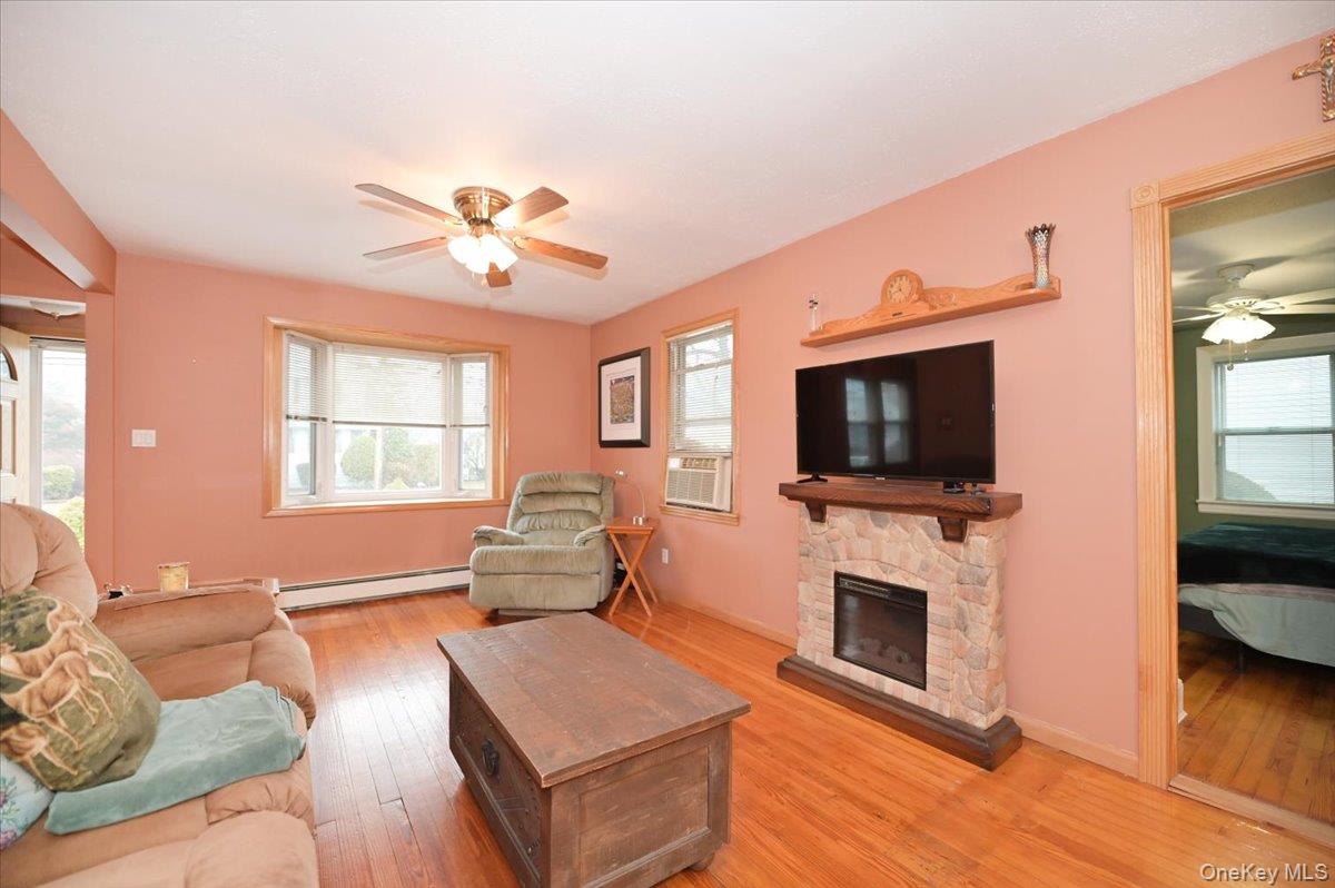 2016 Abbot Avenue Merrick, NY 11566 - Photo 7 of 26 a living room with furniture a flat screen tv and a fireplace