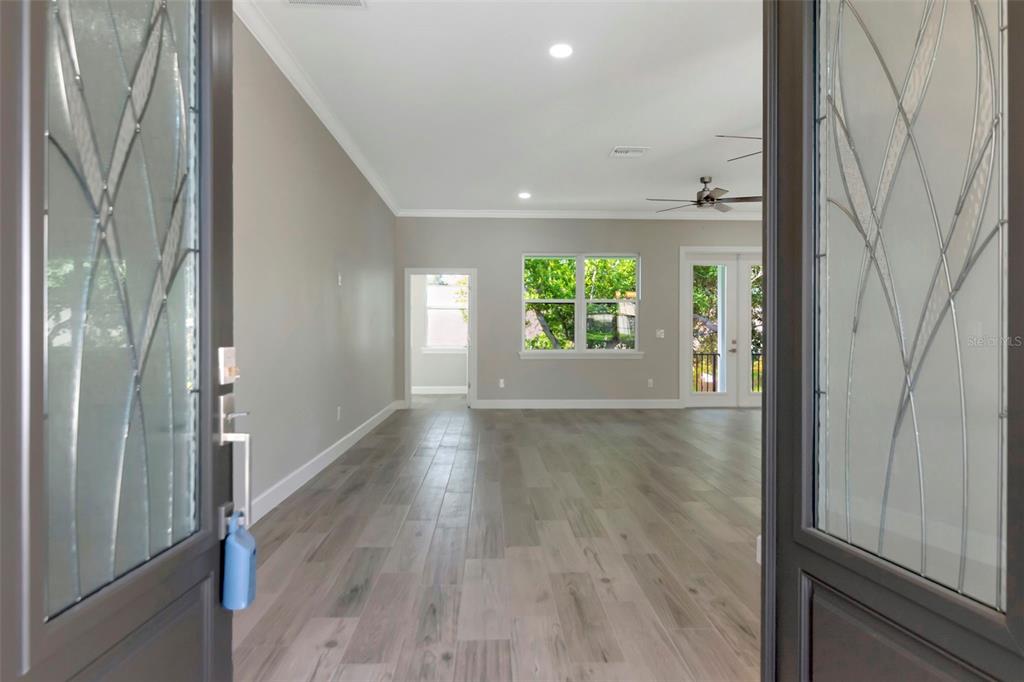 108 Irwin Street East Safety Harbor, FL 34695 - Photo 16 of 79 a view of an empty room with wooden floor and a window