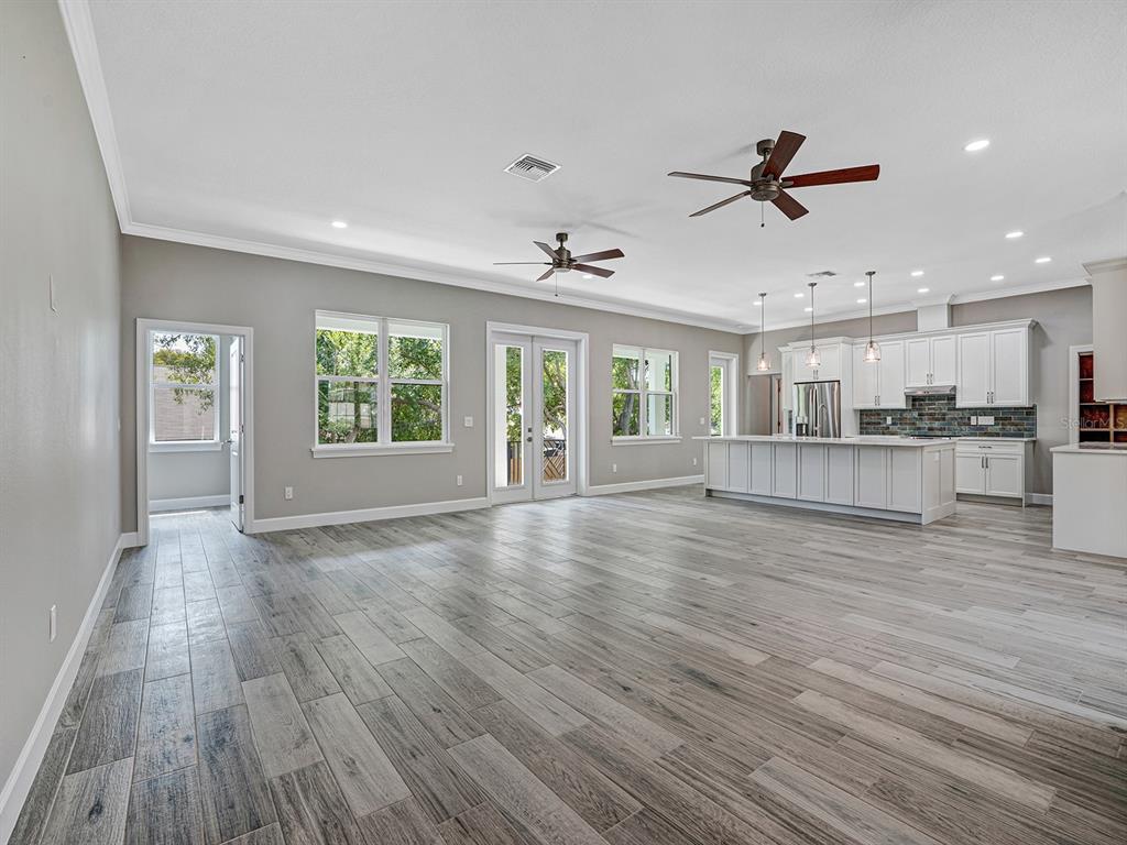 108 Irwin Street East Safety Harbor, FL 34695 - Photo 18 of 79 a view of an empty room with wooden floor and a window