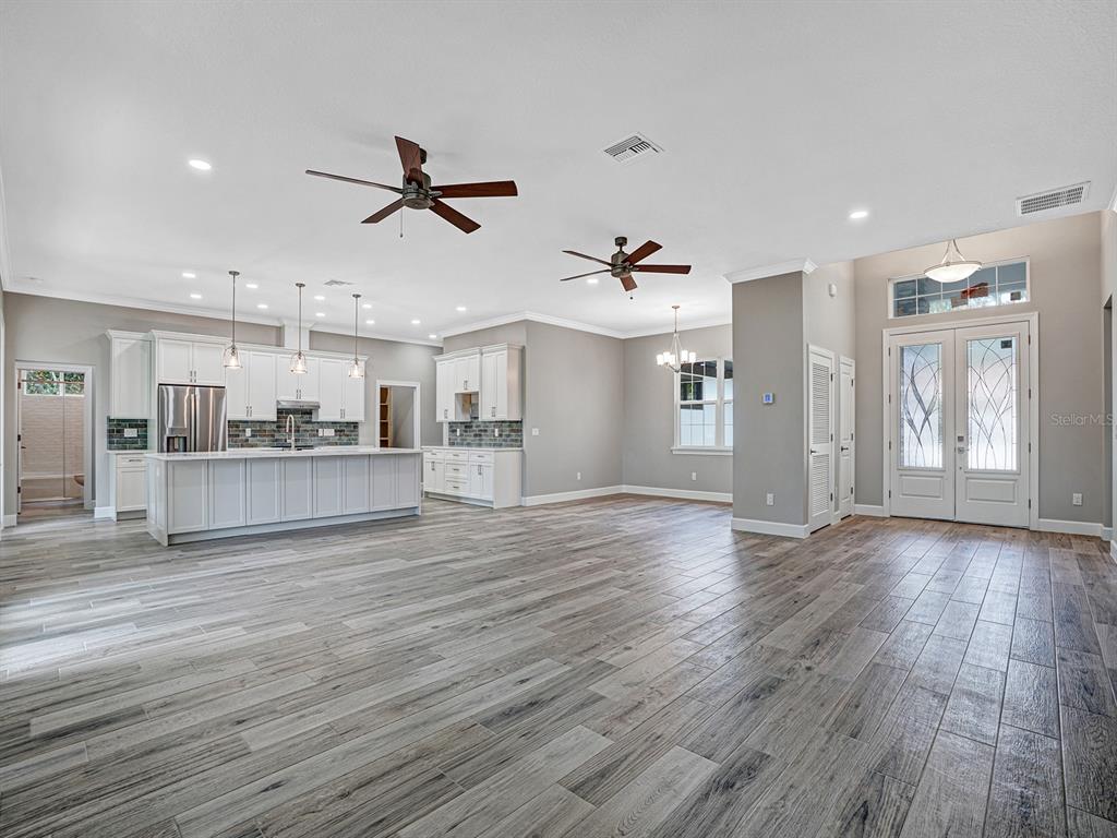 108 Irwin Street East Safety Harbor, FL 34695 - Photo 33 of 79 an empty room with wooden floor and windows