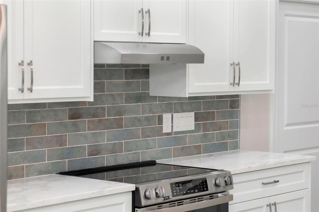 108 Irwin Street East Safety Harbor, FL 34695 - Photo 36 of 79 a view of stove with cabinets