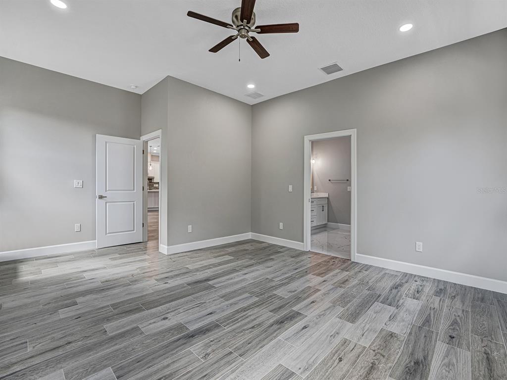 108 Irwin Street East Safety Harbor, FL 34695 - Photo 41 of 79 wooden floor in an empty room with a window