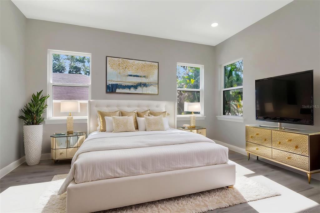 108 Irwin Street East Safety Harbor, FL 34695 - Photo 45 of 79 a bedroom with a bed and a flat screen tv