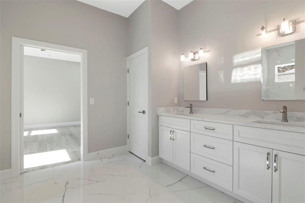 108 Irwin Street East Safety Harbor, FL 34695 - Photo 51 of 79 a bathroom with double sink and a mirror