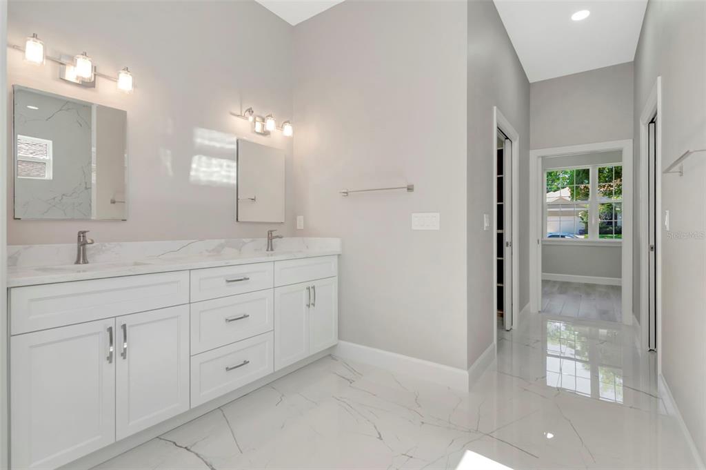 108 Irwin Street East Safety Harbor, FL 34695 - Photo 52 of 79 a spacious bathroom with double sink and shower