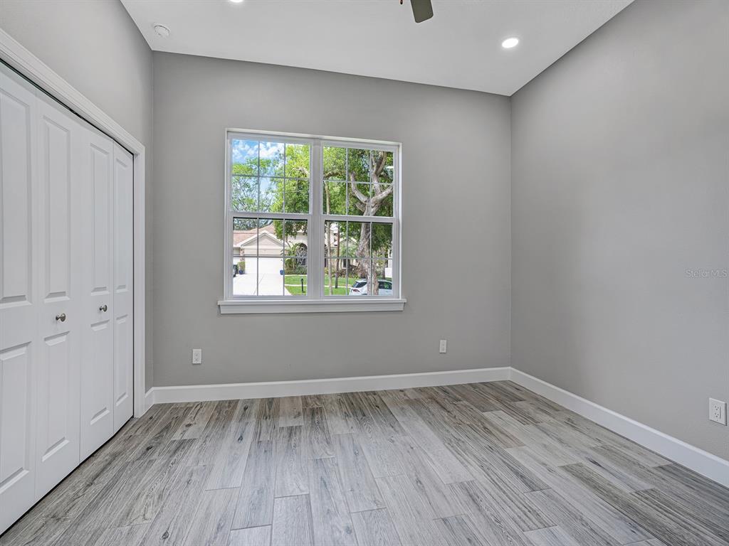 108 Irwin Street East Safety Harbor, FL 34695 - Photo 63 of 79 wooden floor in an empty room with a window