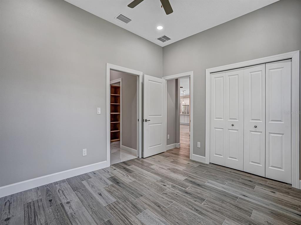 108 Irwin Street East Safety Harbor, FL 34695 - Photo 65 of 79 an empty room with wooden floor closet and windows
