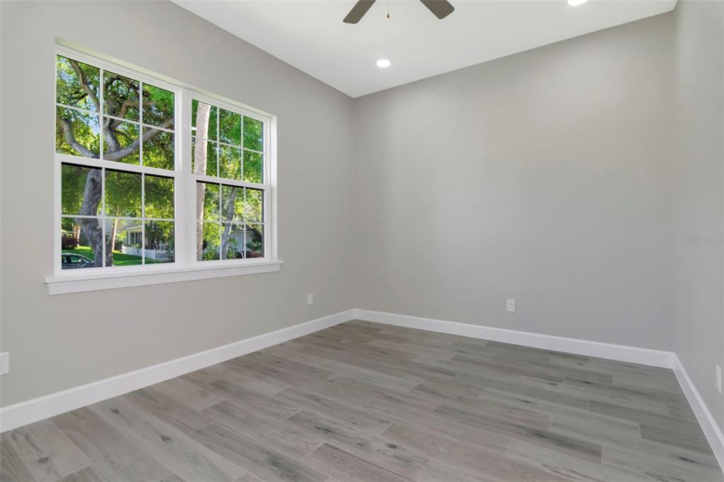 108 Irwin Street East Safety Harbor, FL 34695 - Photo 72 of 79 a view of empty room with wooden floor and fan