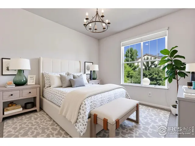 a living room with a bed furniture and a potted plant