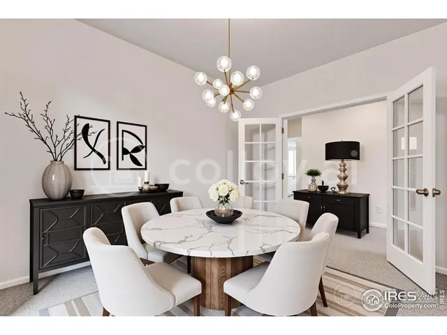 a view of a dining room with furniture and chandelier