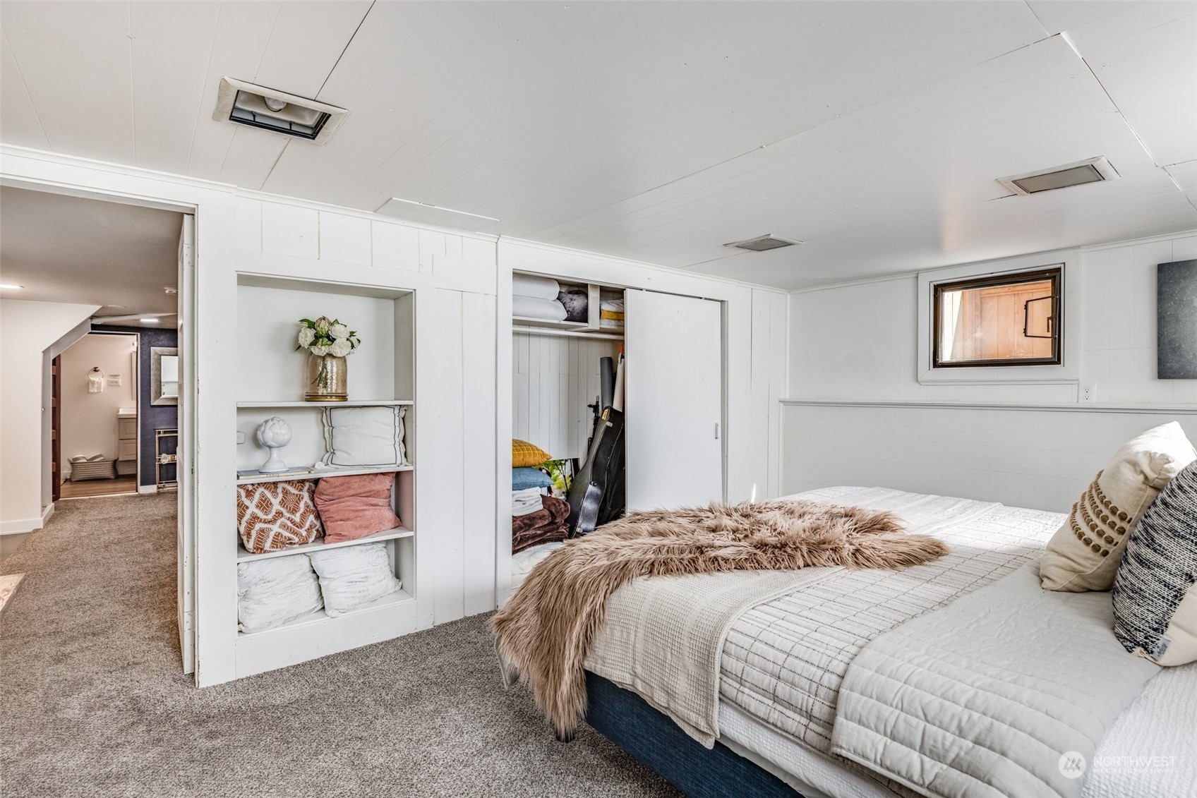 343 North 81st Street Seattle, WA 98103 - Photo 30 of 38 a bedroom with a large bed and a walk in closet