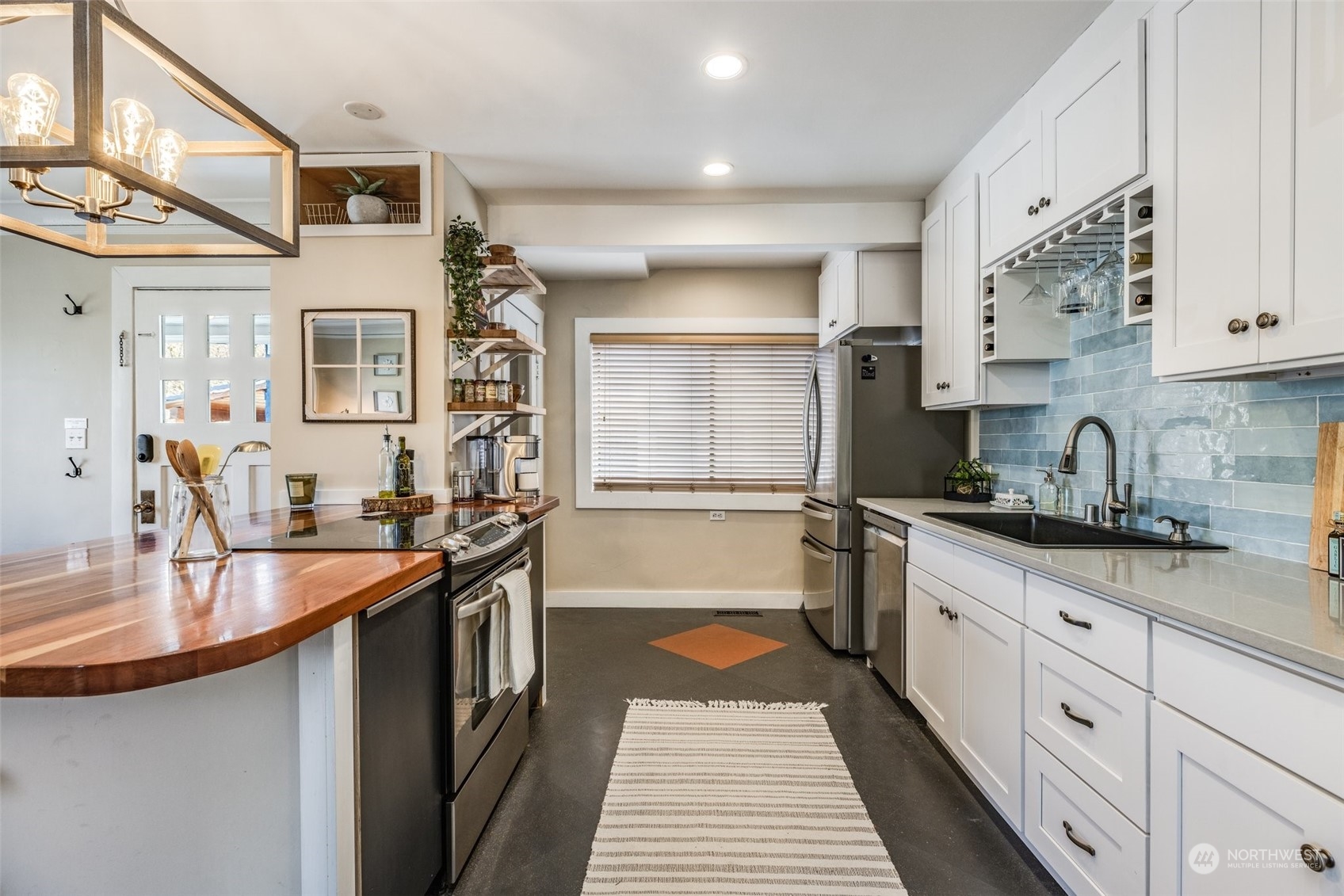343 North 81st Street Seattle, WA 98103 - Photo 6 of 38 a kitchen with granite countertop a sink stove and cabinets