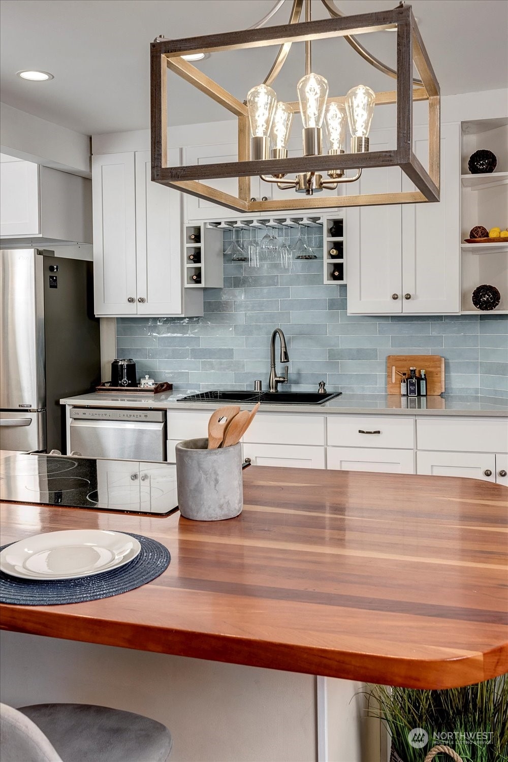 343 North 81st Street Seattle, WA 98103 - Photo 9 of 38 a kitchen with stainless steel appliances granite countertop a sink dishwasher and cabinets with wooden floor