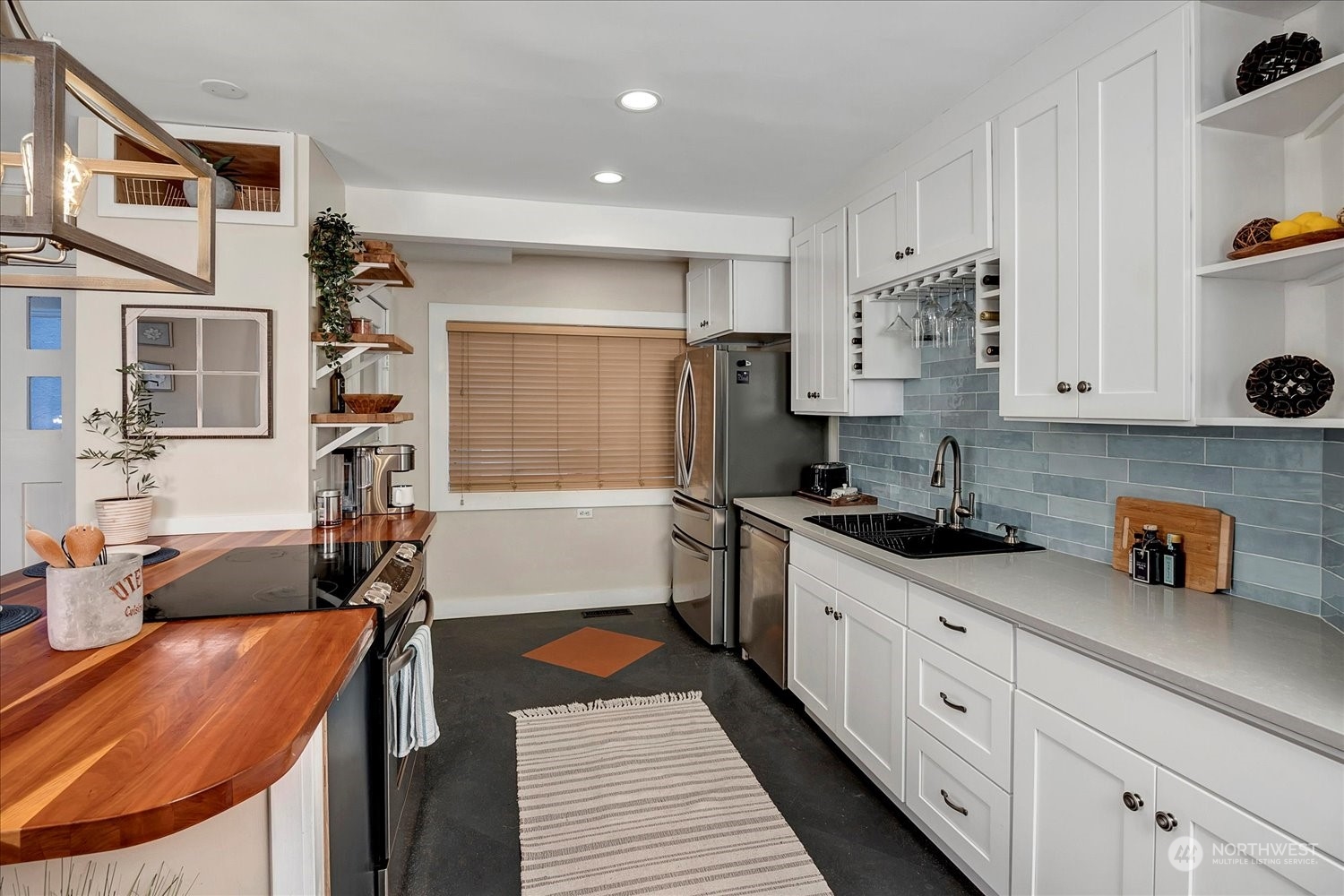 343 North 81st Street Seattle, WA 98103 - Photo 10 of 38 a kitchen with stainless steel appliances a sink stove and cabinets