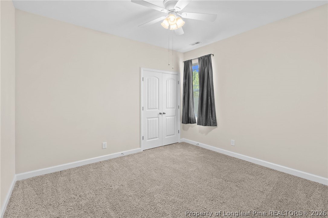 216 Meherrin Loop Raeford, NC 28376 - Photo 30 of 38 an empty room with windows and fan