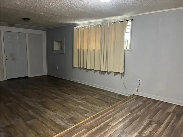 a view of a room with wooden floor and windows