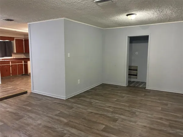 a view of an empty room with closet area