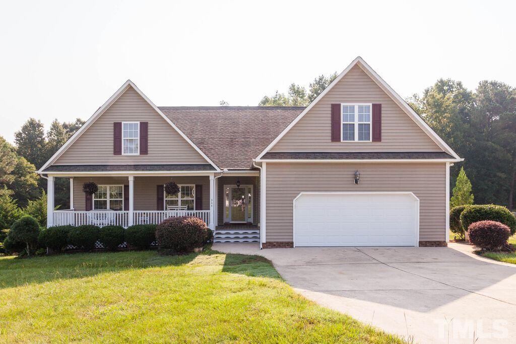 344 Steve Ridge Willow Spring, NC 27592 - Photo 1 of 18 a front view of a house with a yard and garage