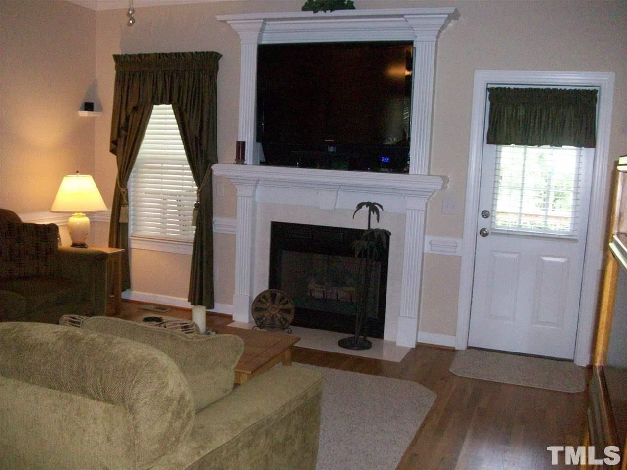 344 Steve Ridge Willow Spring, NC 27592 - Photo 6 of 18 a living room with a flat screen tv and a fireplace