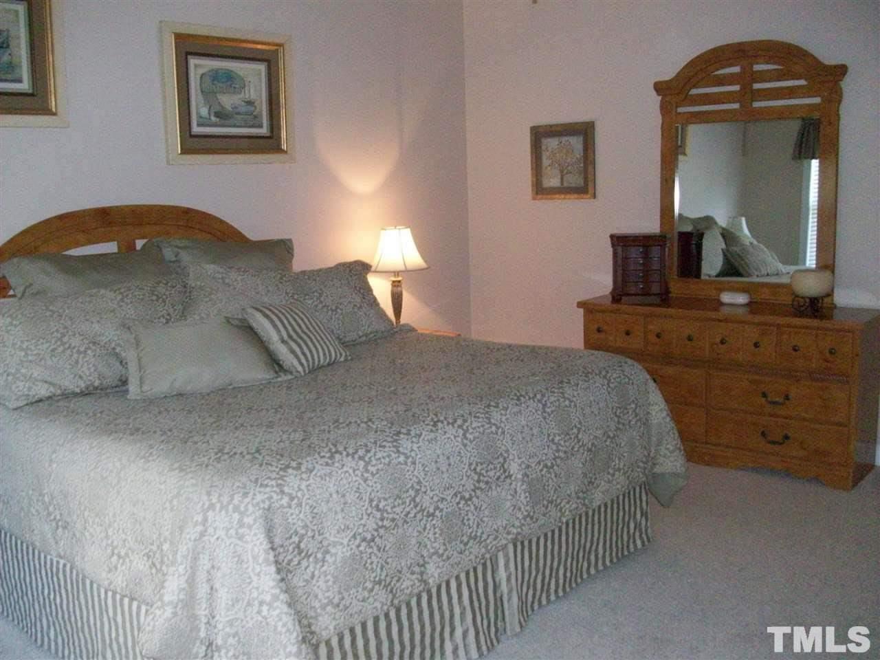 344 Steve Ridge Willow Spring, NC 27592 - Photo 7 of 18 a bedroom with a bed and a dresser