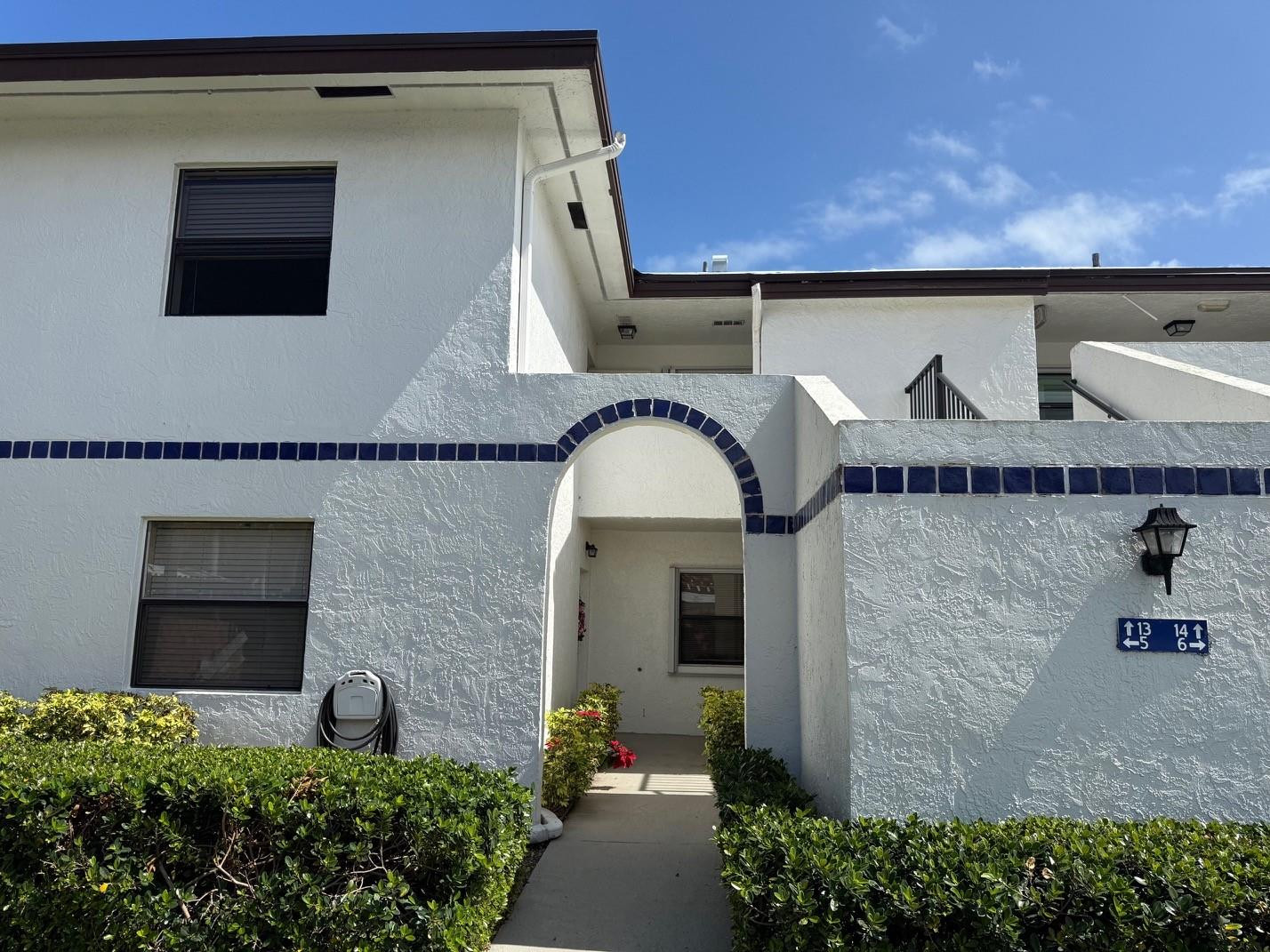 6102 Southeast Landing Way, Unit 13 Stuart, FL 34997 - Photo 13 of 14 a front view of a house with plants