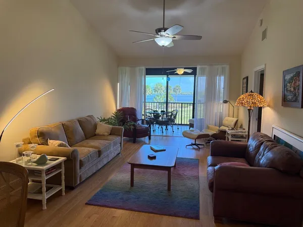 a living room with furniture a chandelier and a window