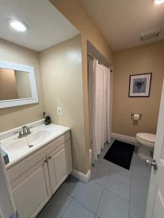 a bathroom with a sink mirror and toilet