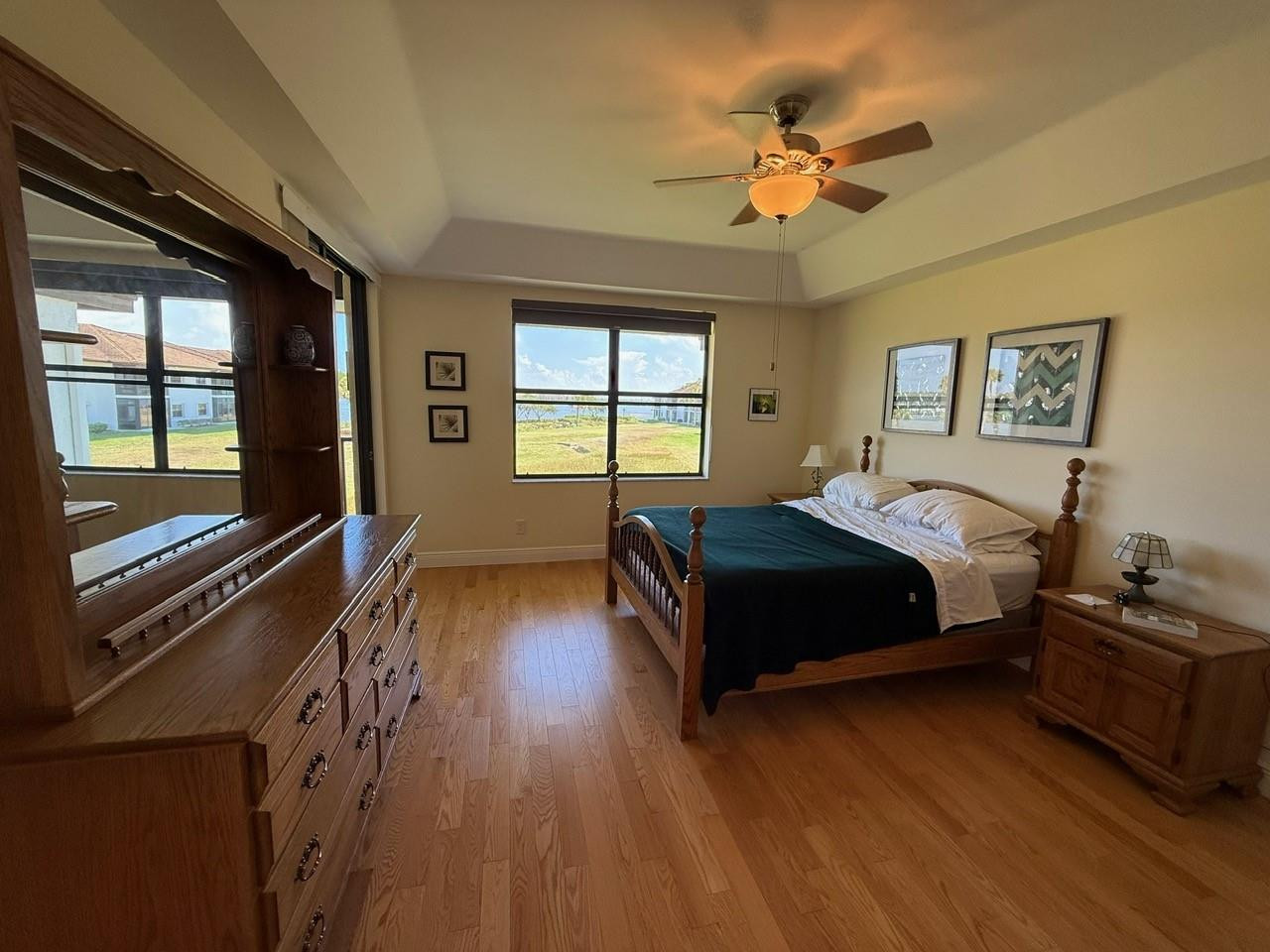 6102 Southeast Landing Way, Unit 13 Stuart, FL 34997 - Photo 9 of 14 a bedroom with a bed and a large window with wooden floor