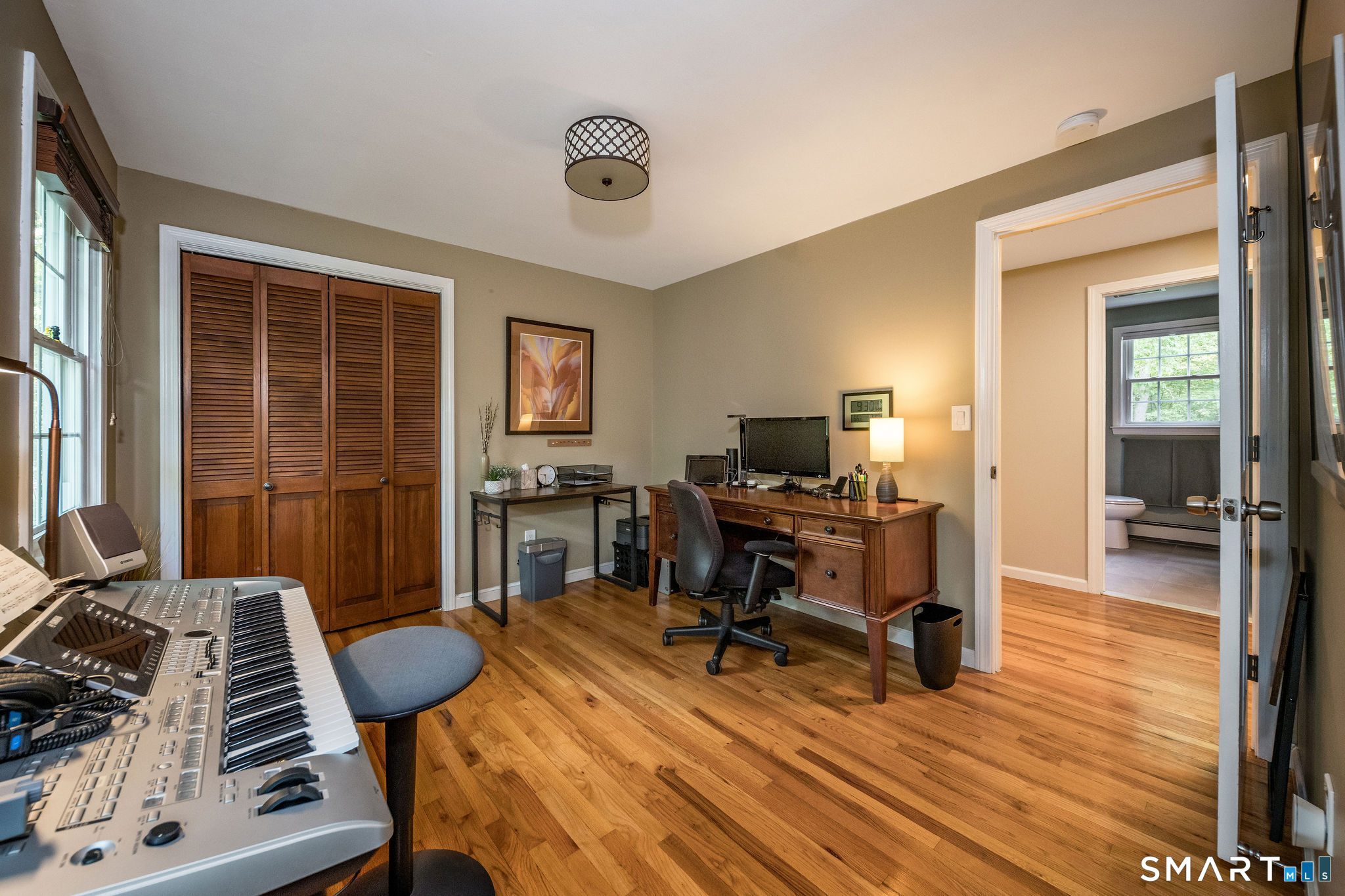 60 Bradley Corners Road Madison, CT 06443 - Photo 23 of 33 a view of a workspace with furniture and a window