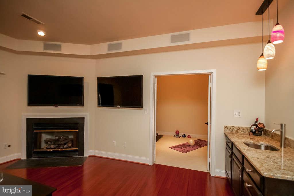 11560 Hemingway Drive Reston, VA 20194 - Photo 14 of 29 a room with a flat screen tv and a fireplace