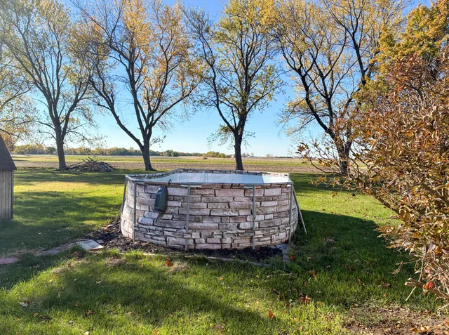 a view of a house with a yard and sitting area