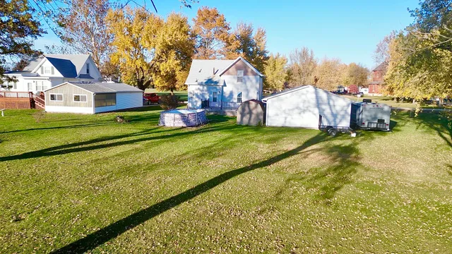 a view of an house with backyard space and balcony