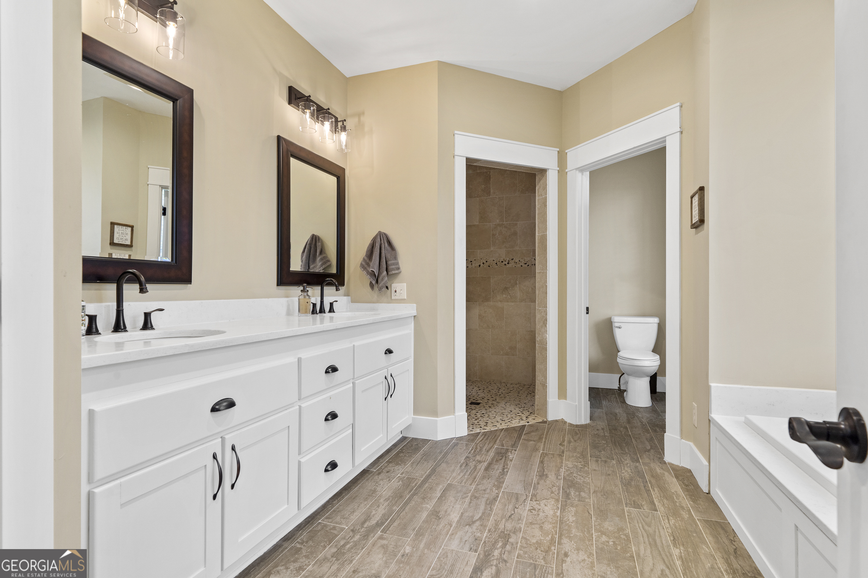 100 Camelrest Lane Eatonton, GA 31024 - Photo 23 of 59 a spacious bathroom with a double vanity sink a mirror and a toilet