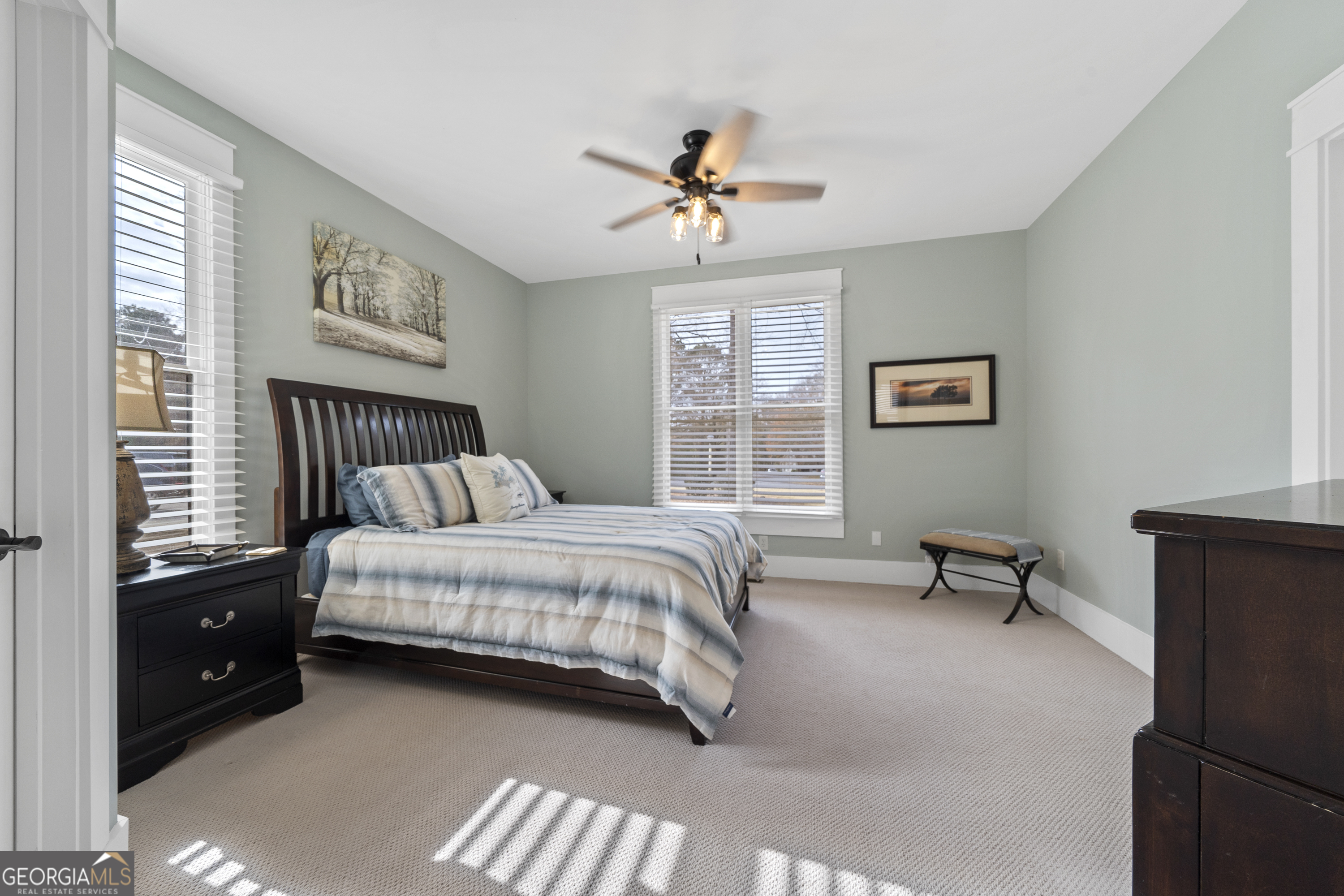 100 Camelrest Lane Eatonton, GA 31024 - Photo 33 of 59 a bedroom with a bed and a chandelier