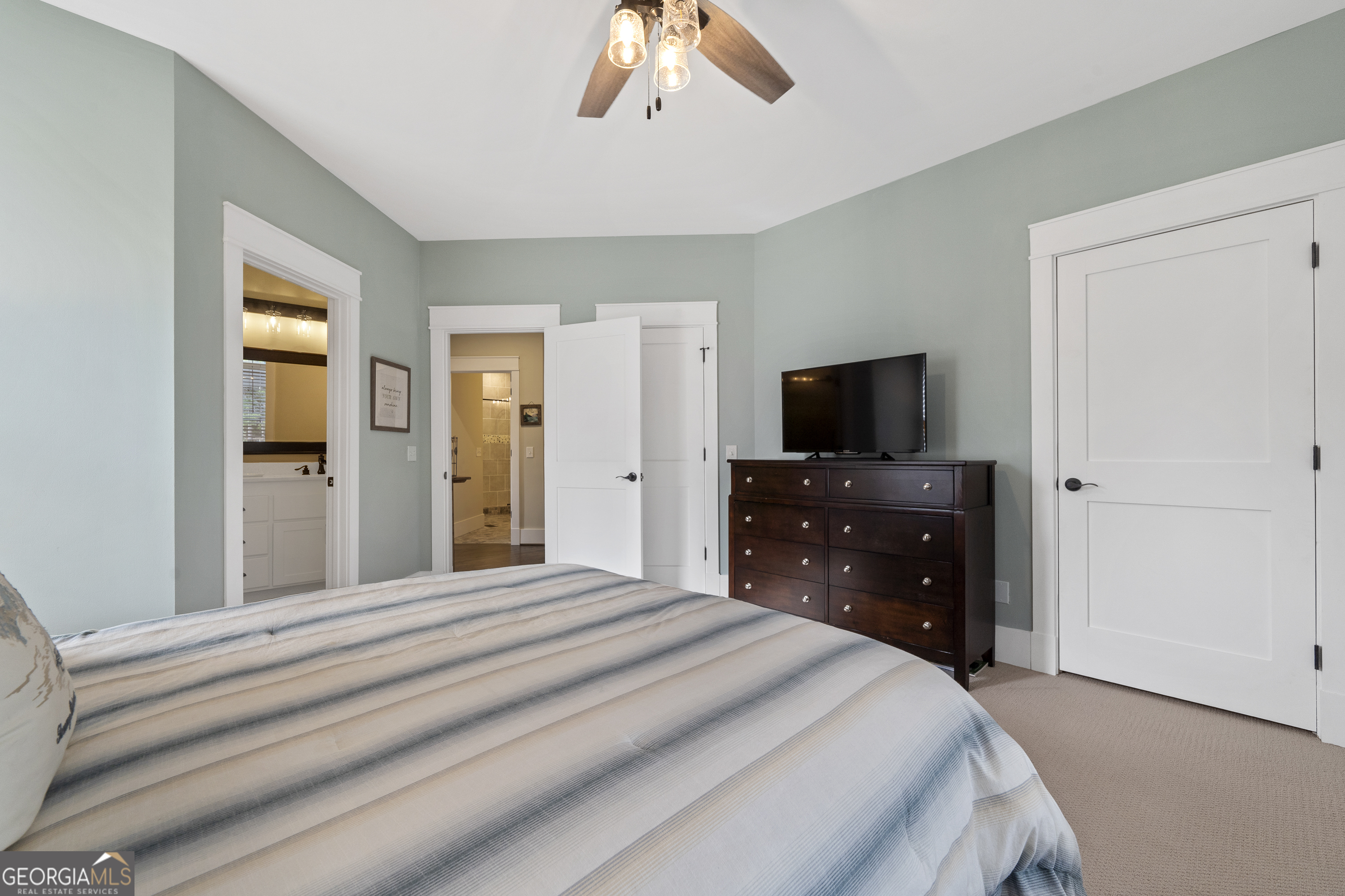 100 Camelrest Lane Eatonton, GA 31024 - Photo 36 of 59 a bedroom with a bed and a flat tv screen on dresser