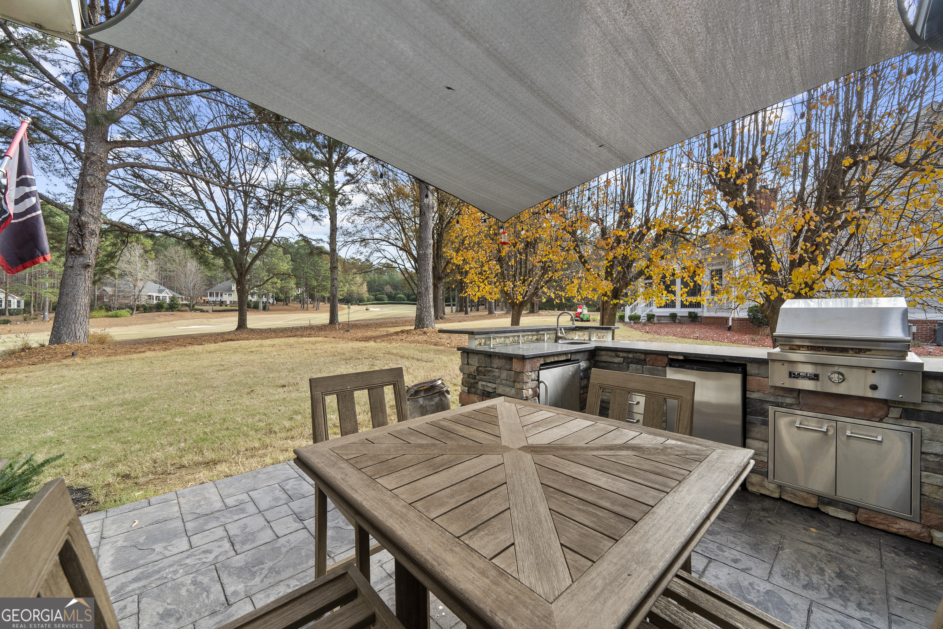 100 Camelrest Lane Eatonton, GA 31024 - Photo 43 of 59 a view of a patio with table and chairs with wooden floor and fence