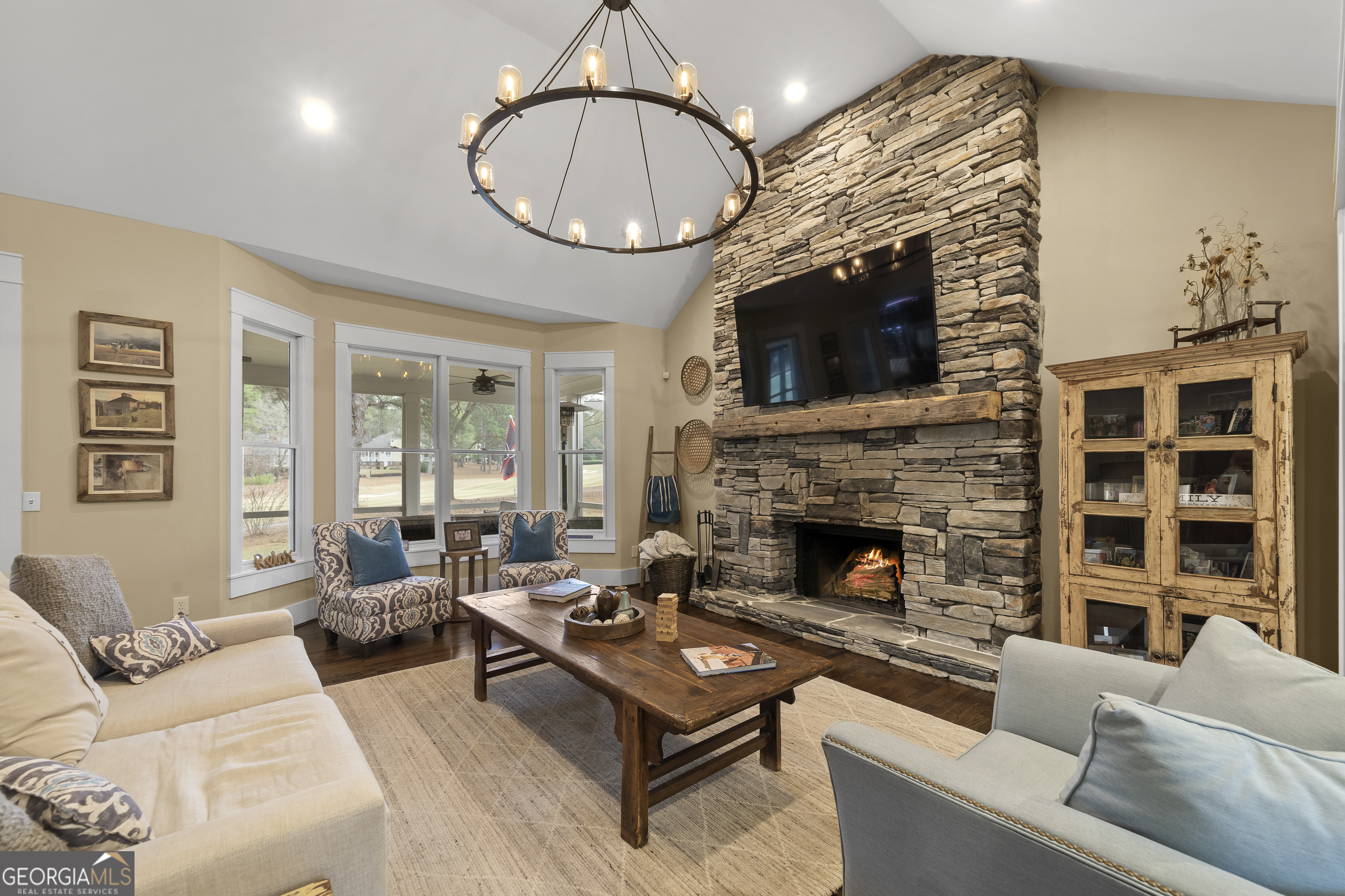 100 Camelrest Lane Eatonton, GA 31024 - Photo 7 of 59 a living room with furniture a fireplace a rug and a large window