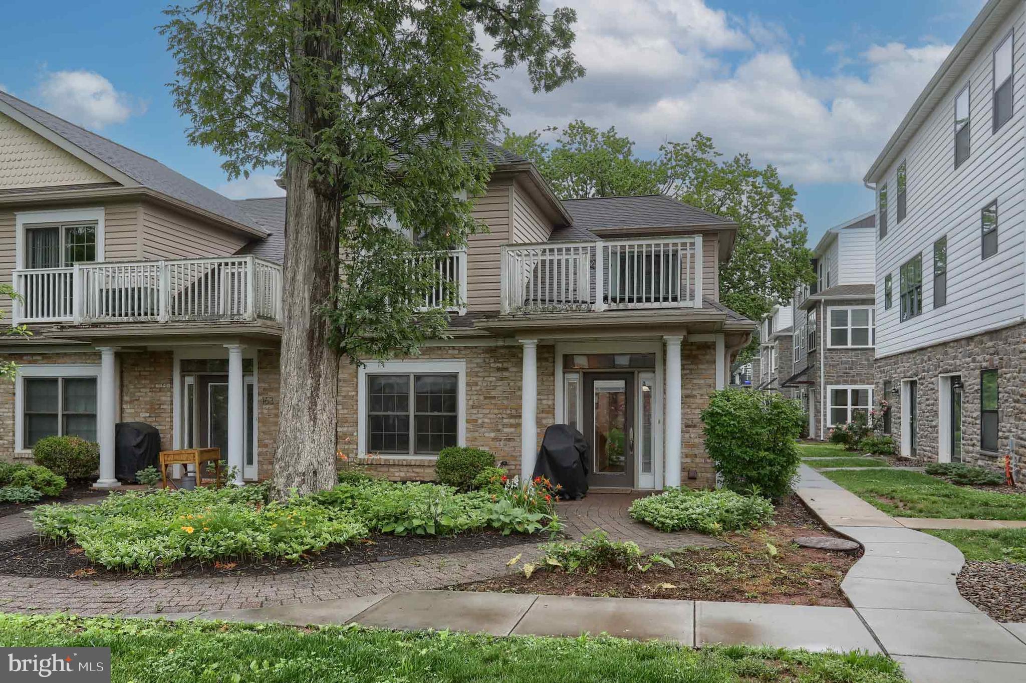 162 High Pointe Drive Hummelstown, PA 17036 - Photo 3 of 38 a view of a brick house with a yard plants and large tree