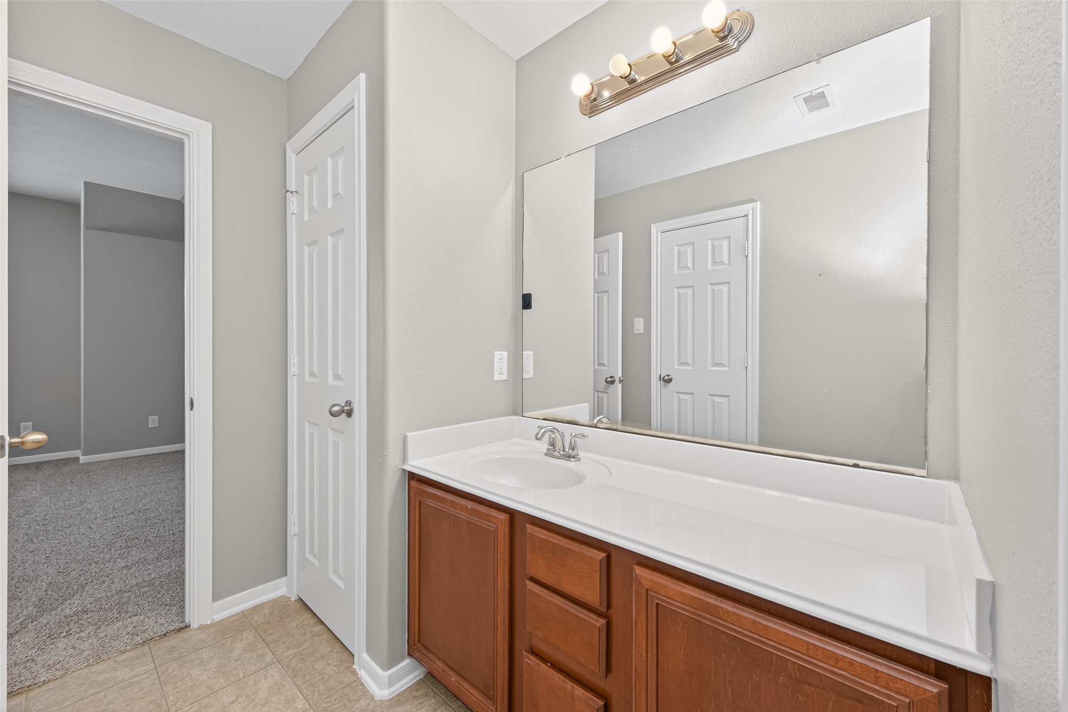 3646 Standing Rock Drive Spring, TX 77386 - Photo 19 of 30 a bathroom with a sink a vanity and a mirror