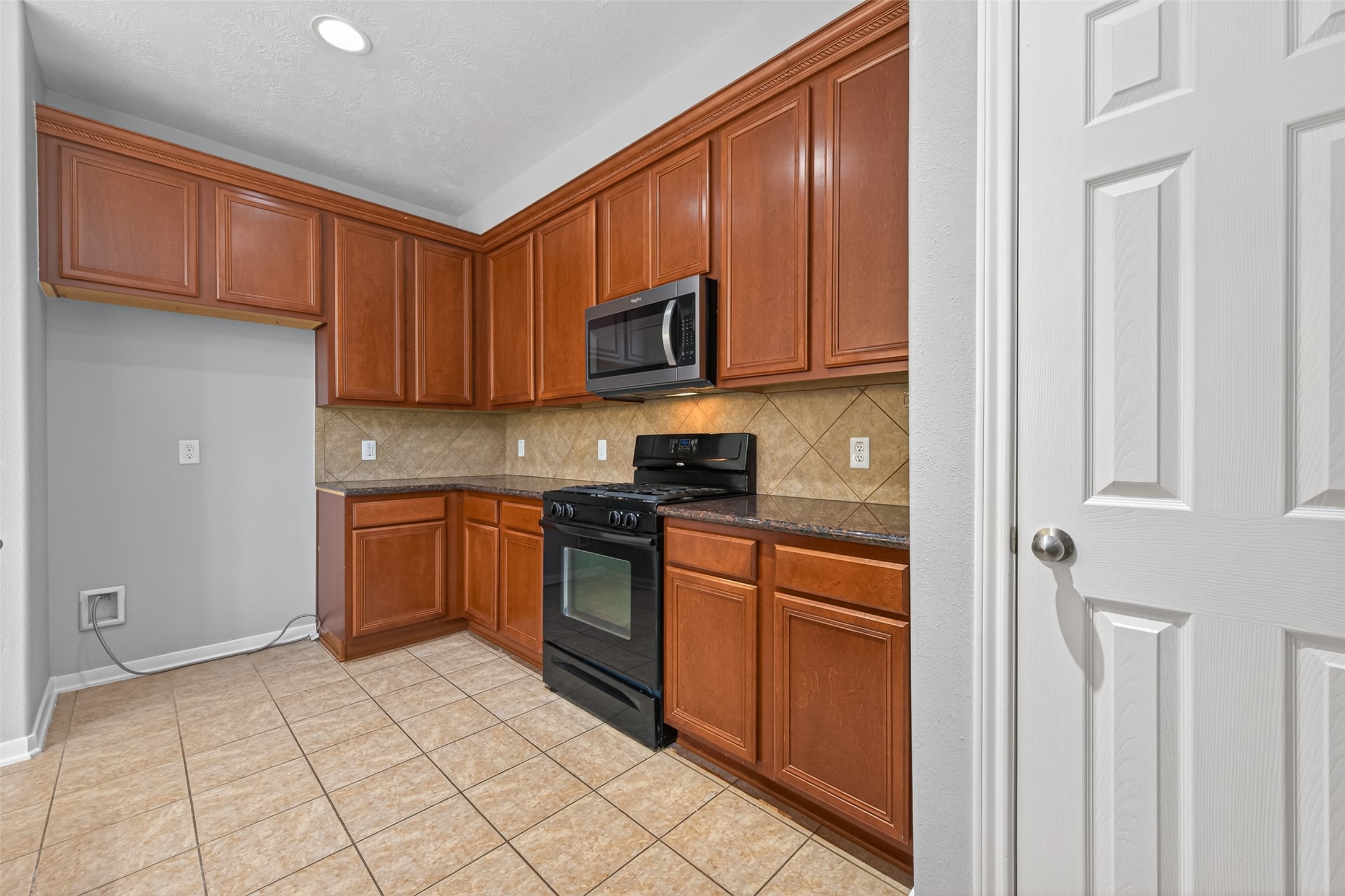 3646 Standing Rock Drive Spring, TX 77386 - Photo 3 of 30 a kitchen with stainless steel appliances granite countertop a stove a sink and a refrigerator with cabinets