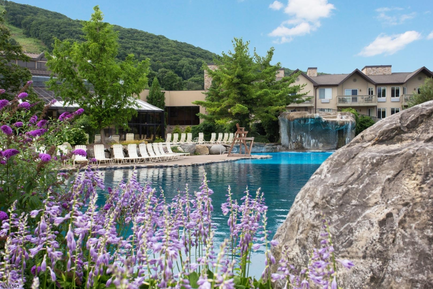 2 Chamonix Drive, Unit 212 Vernon, NJ 07462 - Photo 20 of 21 a view of a lake with a house in background